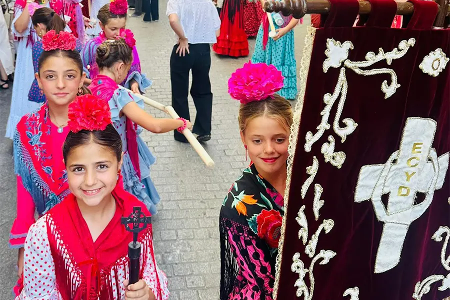 350 adolescentes y jóvenes han salido por las calles de Sevilla en procesión llevando la Cruz de Mayo.